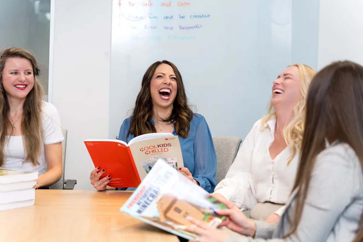 Clinicians laughing while reviewing the Cool Kids® and Chilled program manual