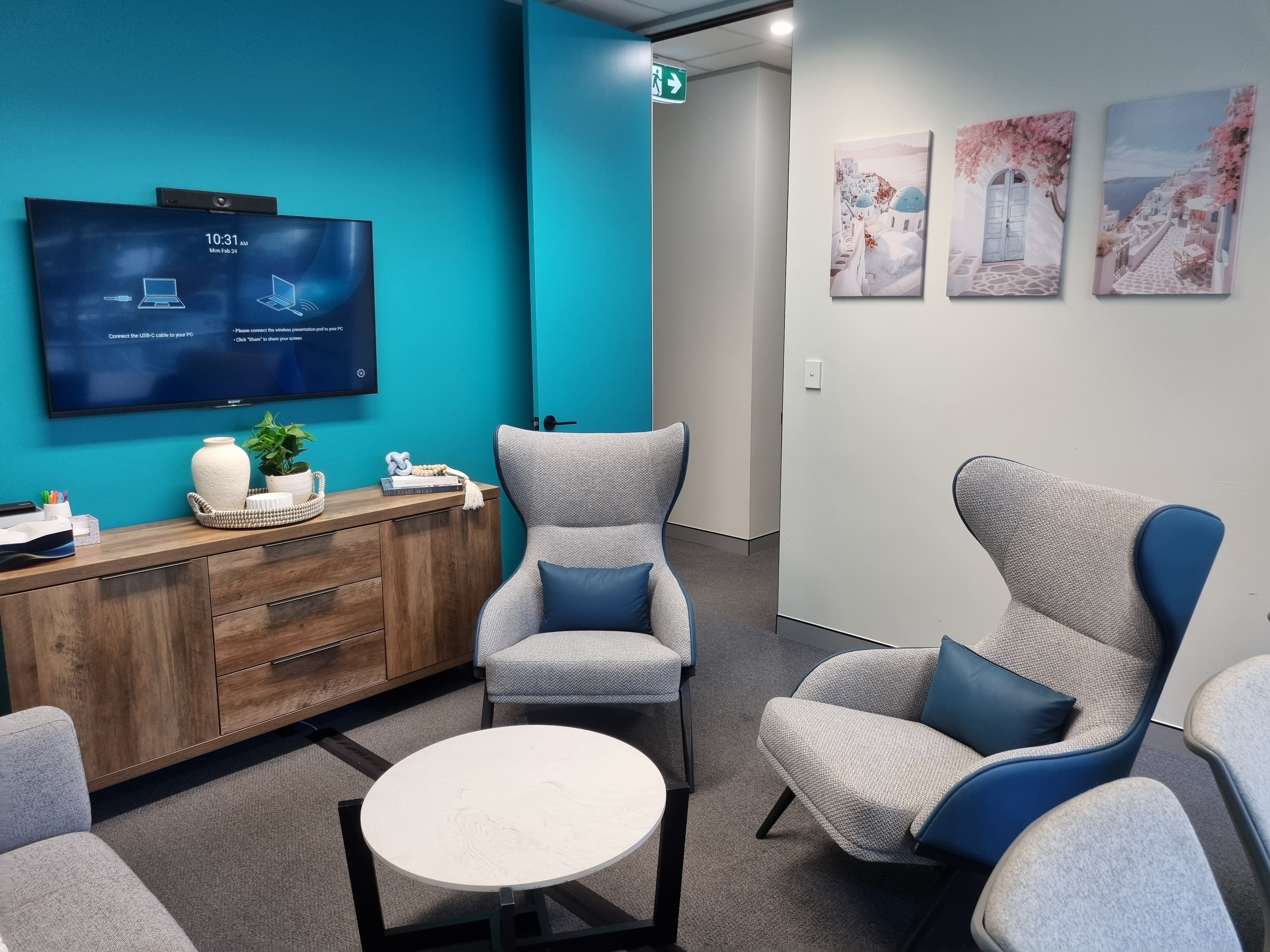 A second breakout room at The Social Space with armchairs and artwork